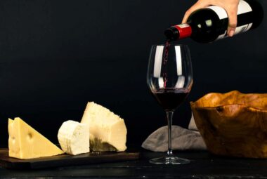 Person Pouring Wine into Glass